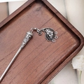 Detail of vintage silver tassel hairpin with floral engraving on a dark wooden tray - F0742 Hair Stick-6# (Hollow Flower Pendant)