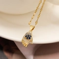 Gold-plated palm pendant necklace with blue gemstone and sparkling crystals - Gold with Blue Stone