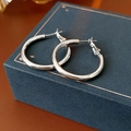 Close-up of minimalist silver hoop earrings on a luxury navy blue jewelry box - Round Hoop Buckle 30mm (Silver Earring Post)