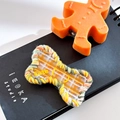 Cute bone-shaped hair clip with yellow woven border and plaid pattern detail - Bone-Plaid Yellow