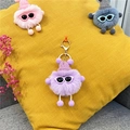 Close-up of cute purple plush soot sprite keychain with knit hat and sunglasses - Taro Purple
