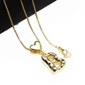 Close-up of gold letter B pendant with colorful zircons and heart charm on a chain - Pendant with Necklace / Letter B