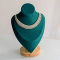 Luxurious five-row silver rhinestone necklace displayed on a dark green velvet bust stand - Medium Green Velvet