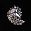 Elegant gold-tone spiral flower brooch with white crystals and a pear-cut center stone - MM-BR-0034 / Gold