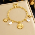 Gold stainless steel pearl flower bracelet with sun pendant on matte gold texture - Sunflower Sun Pearl Style (B1845)