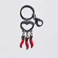 Macro shot of a silver heart-shaped keyring with three red cornicello pepper pendants - Heart Chili Style 28g