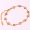 Detalle de la pulsera de oro de 18 quilates con delicados dijes de margaritas en esmalte lila - Pulsera Morada