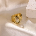 Golden stainless steel wide ring with oval cutout on a luxurious silk background - Letter O / Gold