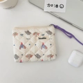 Detail of quilted fabric pouch with elephant print and long purple braided zipper pull - Bowknot Elephant