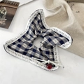 Macro detail of blue plaid scrunchie featuring white lace trim and a shiny red cherry charm - Blue