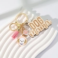 Detail of wooden Dog Mama keychain with pink tassel and dog paw enamel pendant - Pink Tassel + Poodle/Bichon
