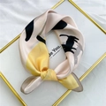 Square silk scarf with beige base and yellow cat print tied in a knot on a golden tray - 53cm / 12 Snow Cat Girl