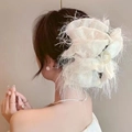 Close-up of white airy mesh cloud hair claw with delicate feathered edges on a bun - Creamy White Shredded Silk-Bubble Claw Clip
