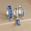 Macro shot of three-piece silver earrings set with sapphire blue cubic zirconia stones - Three-Piece Set / Silver-Blue Zirconia