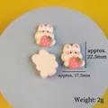 Cute white bunny holding strawberry resin charms for DIY crafts and phone case decor - Style 5 Sitting Rabbit
