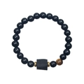 Macro detail of black beaded bracelet featuring tiger eye stones and a square textured bead - Shiny Black & Yellow Tiger Eye Beads With Tourmaline