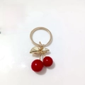 Golden cherry pendant keychain with red beads and leaf details on a white dish - Red Cherry Gold Leaf Single Buckle Charm (Cherry N)