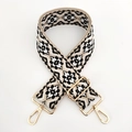 Close-up of ethnic jacquard woven bag strap with geometric patterns and gold metal hooks - Gold Clasp / Black and White Floral