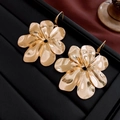 Macro shot of gold floral earrings with hammered metal texture on black display tray - 28# Gold Hammered Metal Flower (Ear Hook)