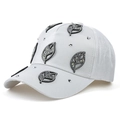 Detail of white baseball cap featuring rhinestone-studded leaf cutouts and silver rivets - White
