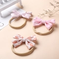Floral bow baby headbands made of soft nylon featuring daisy and wave patterns - Multicolor