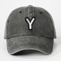Macro detail of the white embroidered letter Y on vintage washed grey cotton baseball cap - Letter Y