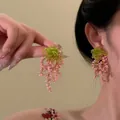 Detail of beaded tassel earrings with green flower top and pink hanging beads - Green Pink Bead Woven Tassel Style (21#)