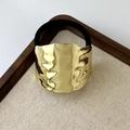 Chic geometric golden hair tie with hammered metal texture and black elastic band - Large Textured Oval