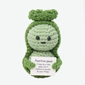 Detail of hand-knitted green pea pod toy holding a positive encouragement card on white background - Peas P Card