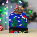 Close-up of blue knitted Christmas hat with dinosaur pattern and glowing LED lights - Cuffed Dinosaur