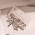 Silver stainless steel earring set with heart and star charms on white satin fabric - Star Bar Set