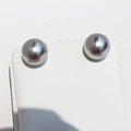 Elegant silver grey round pearl stud earrings with mirror luster on white display - 12mm 925 Sterling Silver Post Earring