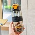 Detail of black sports water bottle with straw, calorie silicone sleeve and orange safety lock - Black