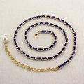 Detail of gold metal waist chain with blue woven ribbon and pearl drop pendant - Royal Blue