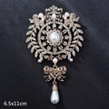 Vintage gold brooch with crystals and teardrop pearl pendant, measuring 6.5x11cm - Luxury Bowtie Crown