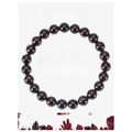 Detail showing 8mm garnet beads on elastic cord with informative crystal energy card - Garnet Bracelet