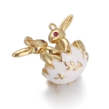 Detail of golden bunny hatching from an enamel egg charm with red gemstone eyes - White Easter Egg Rabbit Pendant