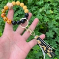 Detail of beaded keychain bracelet featuring sunflower tassel and leopard print beads - Sunflower Printed Tassel Yellow Black Beaded (款8)