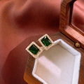 Macro detail of gold-plated leaf earrings with green zircon and sparkling halo inlay - Green (Silver Needle)