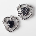 Macro detail of silver heart pendants with black zircon stones and barbed wire punk design - Silver Base Black Zirconia