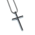 Macro detail of silver cross pendant with black inlay on a polished metal chain - Xl0318* Chain Length 60cm