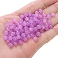 Purple glass jelly round beads for DIY jewelry making held in a palm on white background - Light Purple approx 50pcs/pack