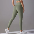 Rear view of high-waisted olive green yoga leggings showing butt-lifting seam details - S / Green-Gray