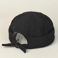 Detail of adjustable strap and fabric texture on a black cotton docker hat for men - Black