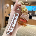 Coca-Cola Flüssigkeit Schlüsselanhänger mit braunem Band und goldener Glocke - Braune Limonadenflasche