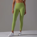 Détail du legging de yoga vert avocat à taille haute montrant la compression sans couture - XS / Vert Fruit Moyen