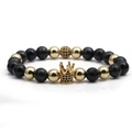 Detailed macro view of beaded crown bracelet with black natural stones and gold accents - Dark Blue Tiger Eye Gold
