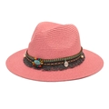 Detail of pink straw fedora featuring bohemian beads, turquoise stone, and tassel trim - Pink