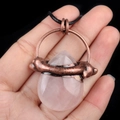 Vintage bronze necklace with pink crystal teardrop pendant in a unique snake wrap design - Rose Quartz
