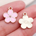 Pink enamel flower charms in gold finish for DIY jewelry making on pink background - Pink Flower (11880)